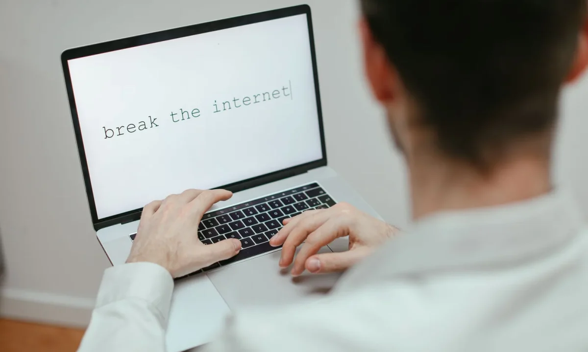 Marketer creating automated content on a laptop displaying the provocative message break the internet