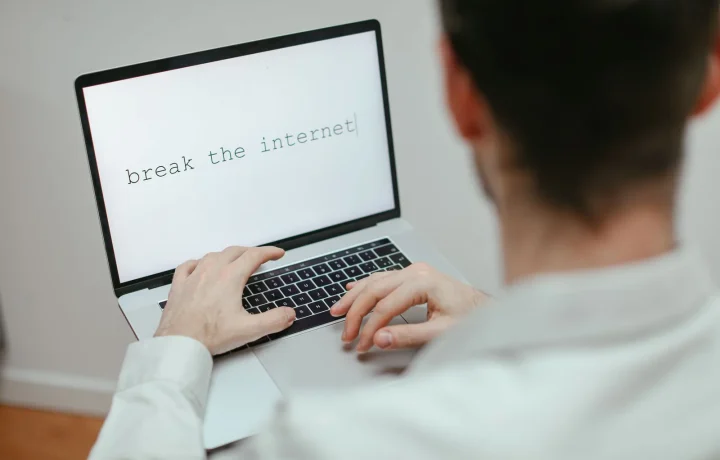 Marketer creating automated content on a laptop displaying the provocative message break the internet