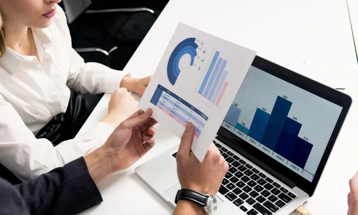 Business team reviewing data charts during a competitive analysis discussion in a modern office
