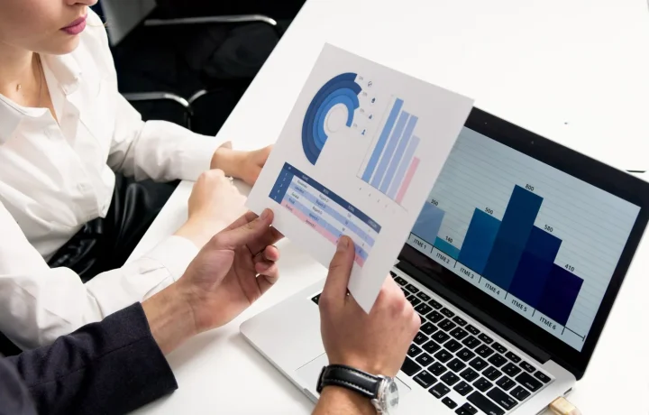 Business team reviewing data charts during a competitive analysis discussion in a modern office