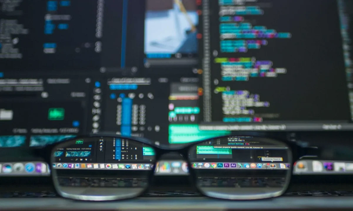 Eyeglasses reflecting lines of code, representing blog schema markup implementation for developers