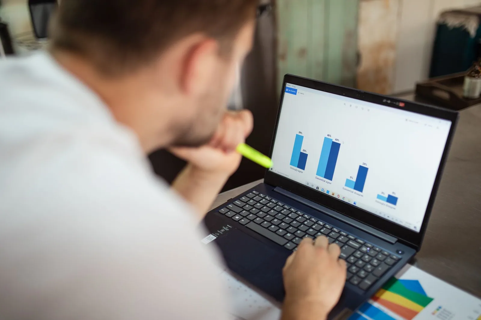 Man examining business charts on a laptop, highlighting the importance of keyword gaps for automated blog owners