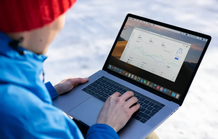 Profissional aplicando técnicas de SEO avançadas em notebook com gráficos ao ar livre no inverno